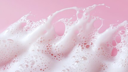 Fototapeta premium 68.Gentle foam swirls from a facial cleanser, soft white bubbles contrasting against a smooth pink background, minimalist beauty composition