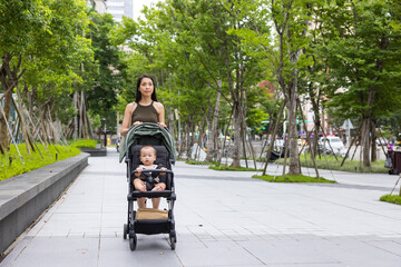 Mum walk with baby on stroller park