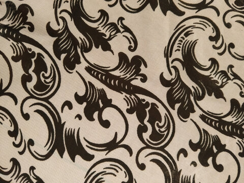 Fototapeta Black ornate floral patterns on a white fabric background, creating an elegant and classic decorative design.