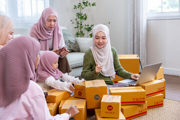 Muslim big family members are packing their product from online marketing at home using cardboard box for business delivery shipment service and modern style selling strategy concept