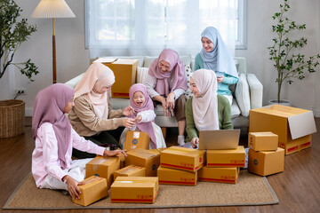 Muslim big family members are packing their product from online marketing at home using cardboard box for business delivery shipment service and modern style selling strategy concept