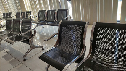 Nganjuk Tuesday August 2025. Rows of chairs queuing at the bank, to depict queues or employee absence. Taken in Asia, Indonesia, red waiting chairs.
