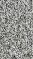 a marble wall with a gray, uneven surface