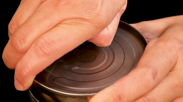 Hand Opening Canned Tomatoes with Pull Tab in Studio Light