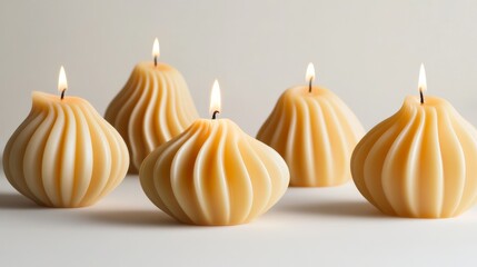 72.Collection of decorative wax candles, minimalist arrangement against a white background, highlighting their elegant curves and smooth textures