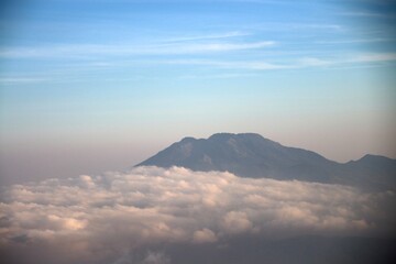 Majestic mountain peaks above a sea of clouds, ideal for travel, adventure, and nature photography...