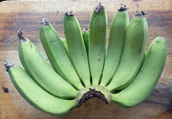 Raw banana bunch full frame closeup. Fresh bunch of unripe green bananas, perfectly healthy,...