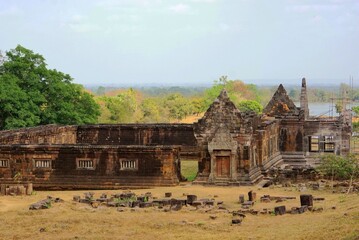 Ancient stone temple ruins at Wat Phu in Champasak, Laos, surrounded by lush greenery