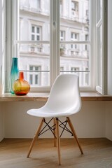 A white plastic chair with wooden legs sits on a hardwood floor before a window showcasing a city view and colorful glass vases