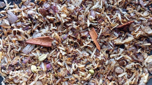 Roasted spice mix for Vatan paste. Roasted dry coconut, onion, cinnamon, clove, coriander, fennel and cardamom ground to a paste, forming aromatic curry base (Vatan) for Maharashtrian chicken curry.