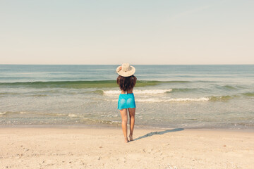 Woman in Blue Dress Standing on Beach Shore