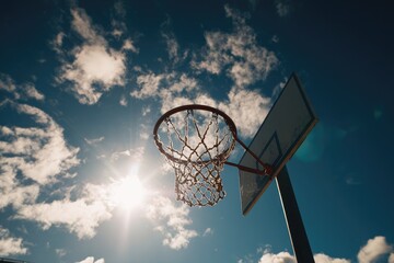 Basketball hoop against a partly cloudy sky