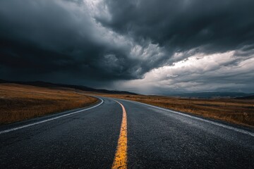 Naklejka premium Stormy road stretches into a clouded sky