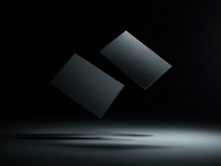 Two dark gray, rectangular, diamond-shaped objects float against a dark background