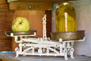 old vintage kitchen scales with glass jar and quince