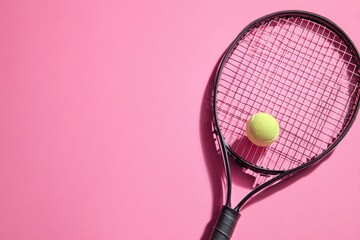 Tennis racket and ball on pink background (2)