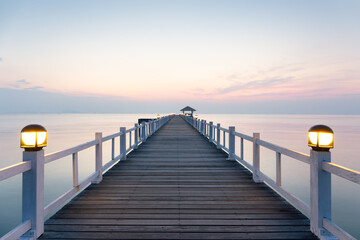Obraz premium Coastal landscape in Chonburi, Thailand. Serene travel destination. Nature meets architectural engineering. Evening sky reflects on sea. Ideal for tourism, scenic beauty and vacation concept.