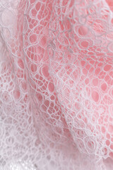 Delicate white lace with circular patterns on soft pink background, evoking romantic softness and elegance, ideal for bridal fashion, feminine design, luxury textiles, and dreamy themes with chiffon