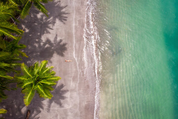 Girl lying on a beach from above in Panama