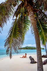 Girl on vacation with a palm tree and white beach