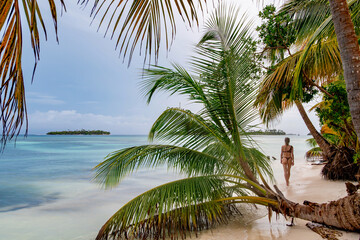 Girl walking on a remote tropical white beach in Panama
