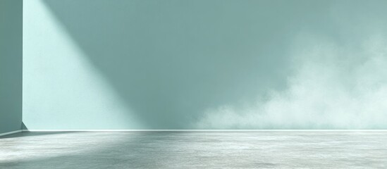 Empty room with mint green walls and light-grey floor. Sunlight casts a shadow