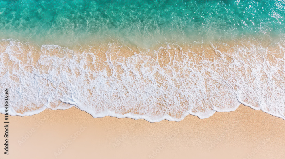 Poster aerial view of waves gently lapping on sandy beach, creating serene and calming atmosphere