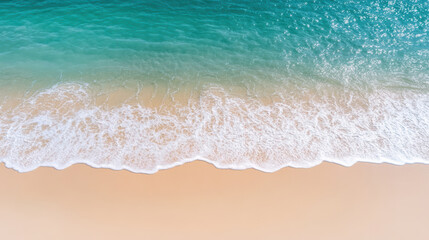 Aerial view of tranquil waves gently lapping on sandy beach, creating serene atmosphere