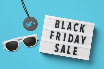 Black friday sale word on lightbox with sale tag and sunglasses on blue background