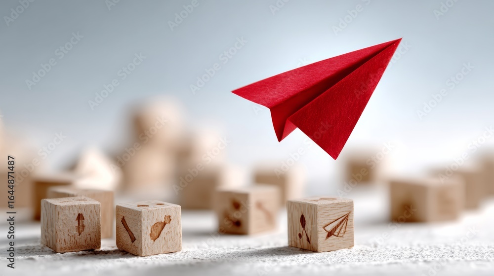 Poster red paper airplane is flying over a pile of wooden blocks. the blocks are arranged in a way that the