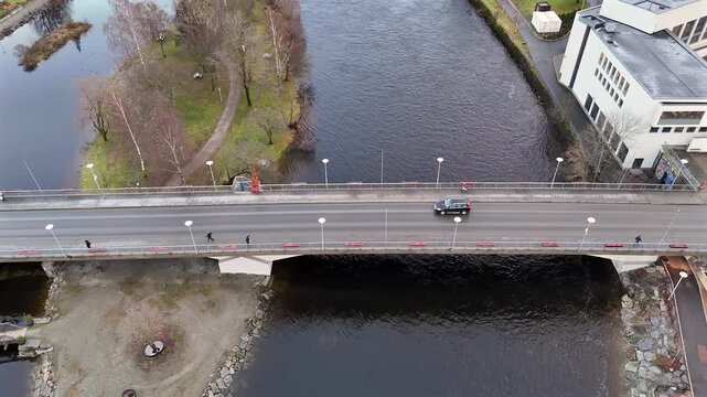Top down view of bridge in Steinkjer with riverside paths and stone embankments 