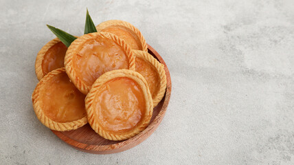 Pie Susu or custard tarts is popular snack from Bali, Indonesia, on grey background