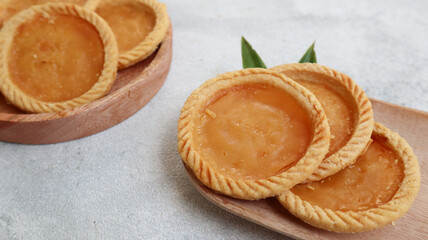 Pie Susu or custard tarts is popular snack from Bali, Indonesia, on grey background
