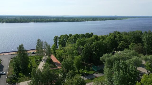 Volga river embankment greenery flourishing in spring sunshine. Clip
