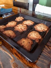 Fototapeta premium Ugly Chocolate Chip Cookies on a baking pan fresh out of the oven with crumbs