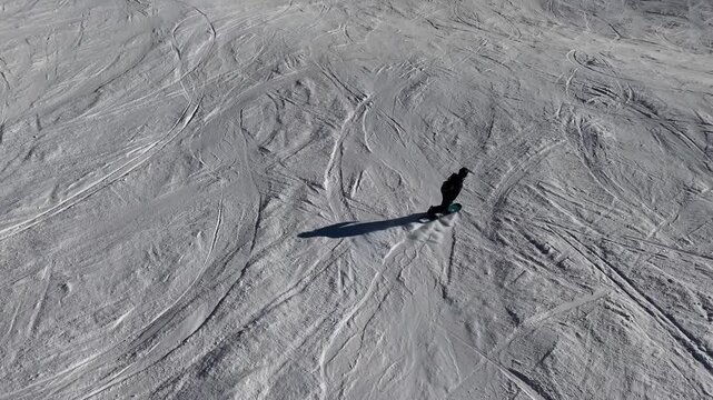 Graceful snowboarding down a wide mountain slope