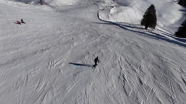 Graceful snowboarding down a wide mountain slope
