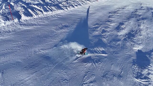 Riding a snowboard with smooth carving turns downhill