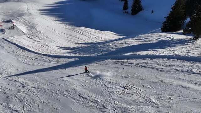 Riding a snowboard with smooth carving turns downhill