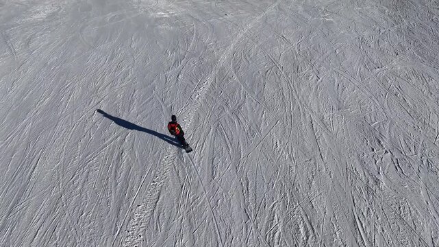 Riding a snowboard with smooth carving turns downhill