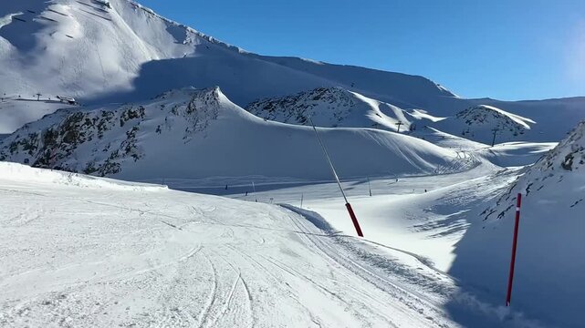 Smooth downward travel along a wide mountain slope