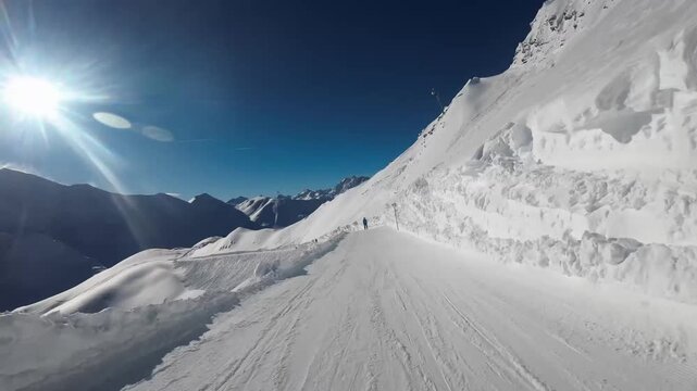 Smooth downward travel along a wide mountain slope