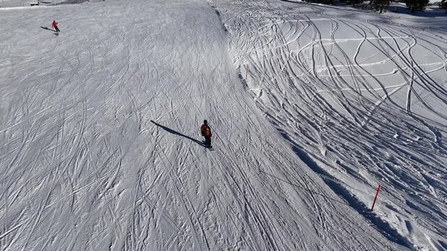 Riding a snowboard with smooth carving turns downhill