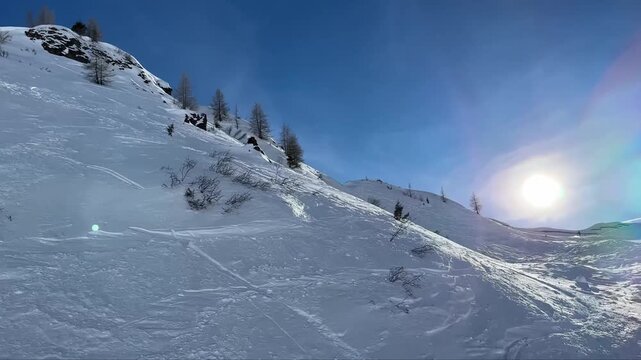 Dynamic downhill skiing on a sunny mountain slope
