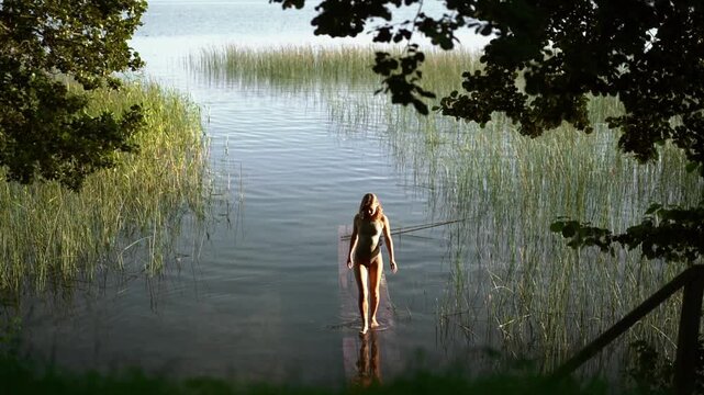 Woman on a wooden pier on a calm lake