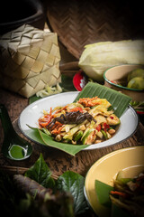 Som Tam , a popular and favourite Thai food dish made of young sliced papaya, chili, tomatoes, palm sugar and dried shrimp.