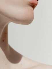 Fototapeta premium Close-up of a woman's neck and upper body. the focus is on her lips and nose, and her skin appears to be clean and well-groomed.