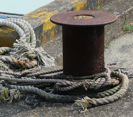 An old steel device installed on the embankment of the fishing port for mooring boats.