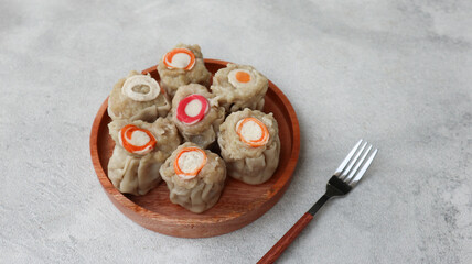 steamed dumpling dimsum. homemade dimsum with various topping served on wooden plate