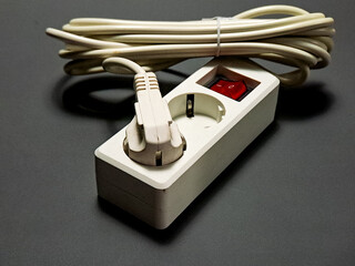 Power outlet with a coiled cord, showcasing a practical solution for electrical distribution, rendered in a minimalist style with a functional aesthetic, and clear organization.